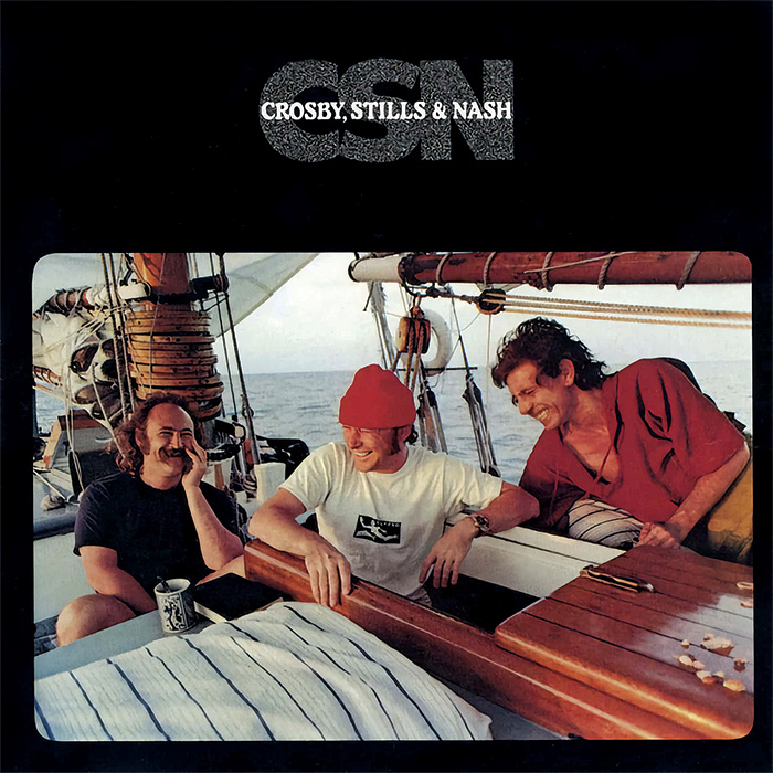 Album cover for CSN featuring Crosby, Stills and Nash breaking into laughter aboard a boat
