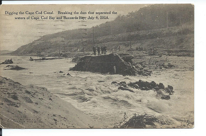 Black and white photo of breaking the dam that separated the waters of Cape Cod Bay and Buzzards Bay on July 4, 1914.