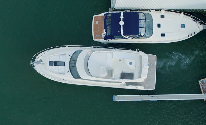 Ariel view of a vessel docking next to another.