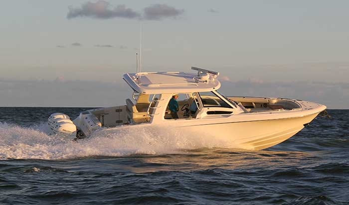 An all white Boston Whaler 350 Realm powerboat underway