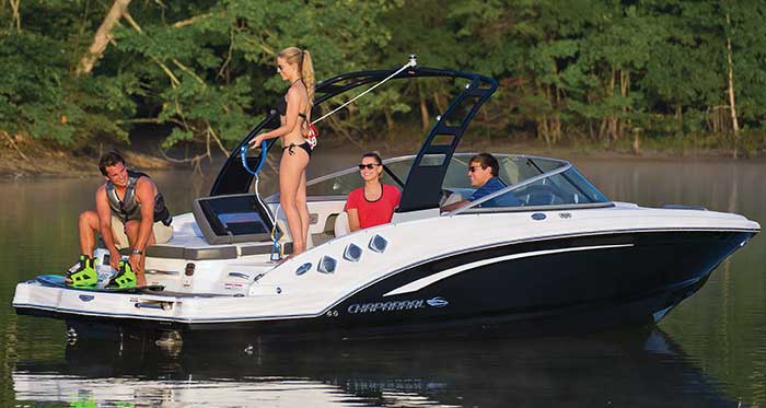 Four passengers get ready to wakeboard onboard a Chaparral 246 SSI Wakeboard powerboat that is anchored