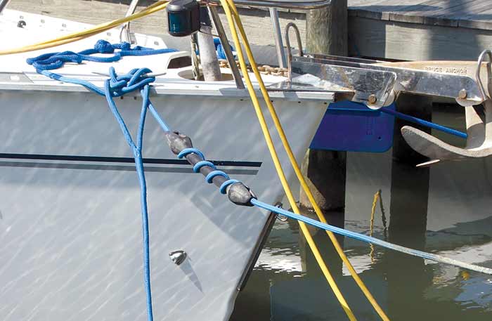 Line snubbers, rubber cylinders threaded through boat lines to absorb the shock of wind and wave movement