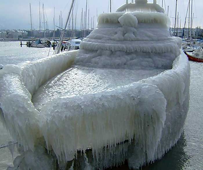 Powerboat totally encased in thick ice while tied to a dock