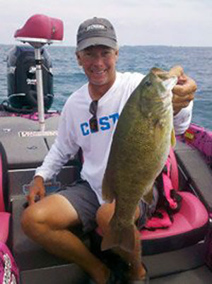 Kevin Short with a smallmouth bass caught on Lake Erie