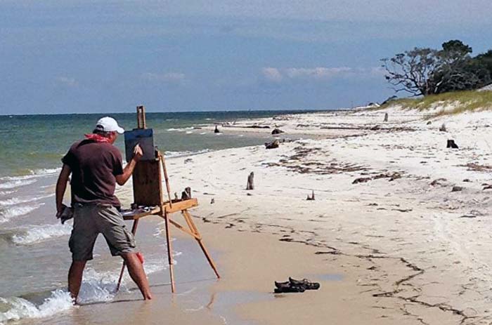 Billy Solitario painting on the beach