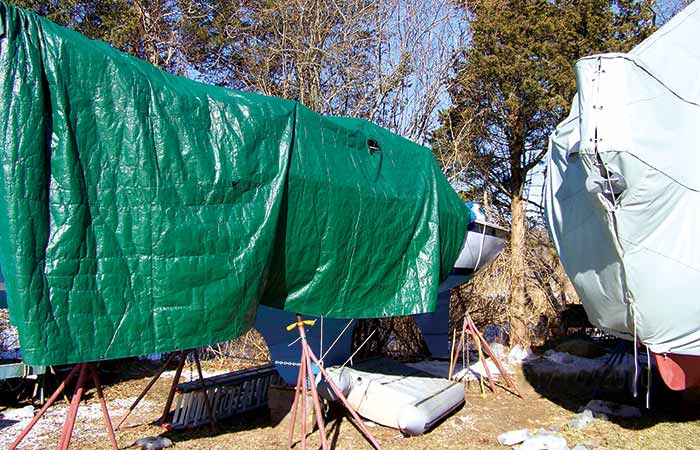 Boat on stilts covered with green tarp