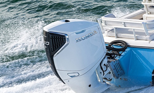 Photo of a white and black Honda  BF350 motor in use on open waters.