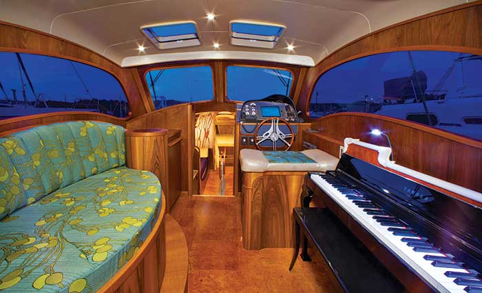 Lionheart's Concerto yacht interior with electric Yamaha player piano nestled to starboard