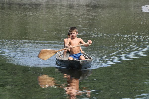 Local Children Paddling on the Amazon River