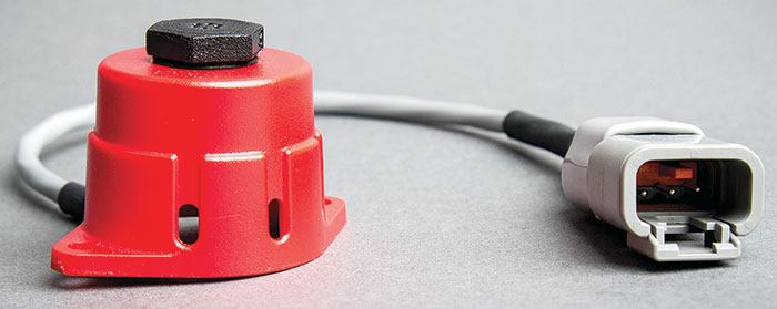 A product shot of a gas and propane sensor - a small orange cylinder with a cord attached