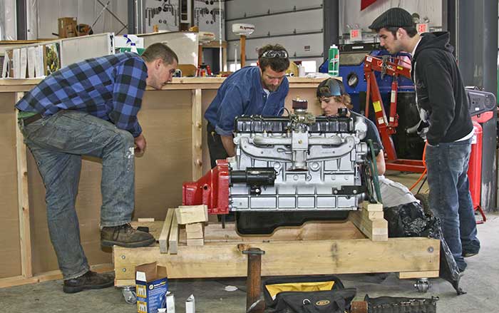 Students working on boat engine