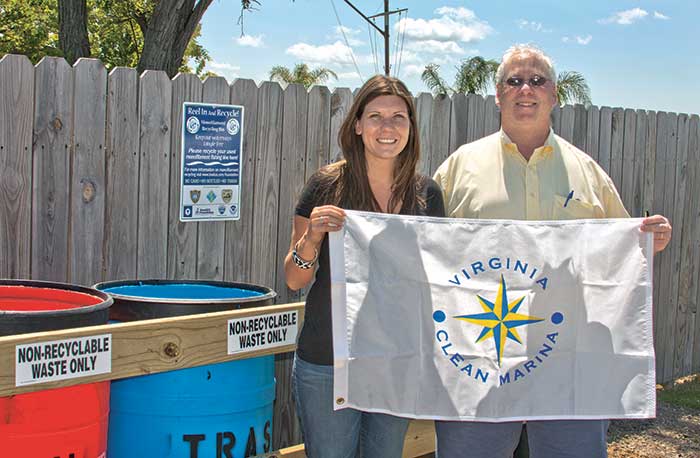 Holding a Virginia Clean Marina flag