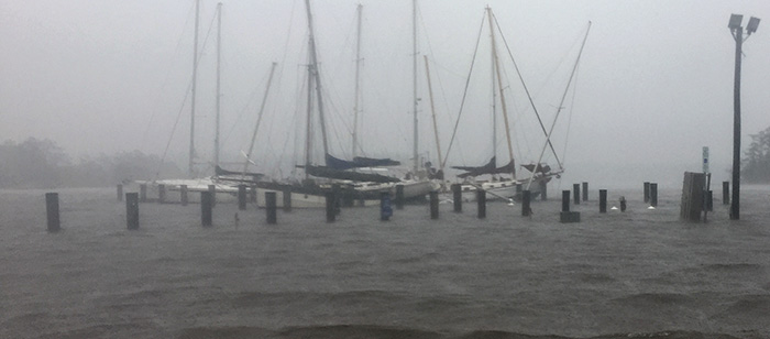 Flooded waters with damaged sailboats
