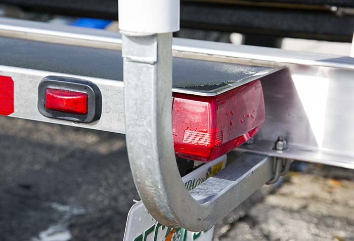 Close-up photo of the rear red tail-lights of a boat trailer