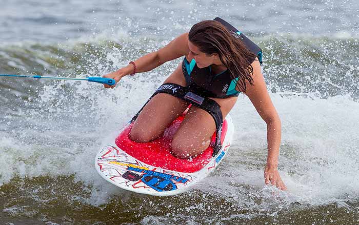 Young girl in the waves riding on a Hydroslide Revolution kneeboard