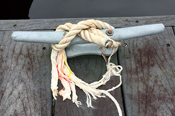 Broken rope tied around cleat
