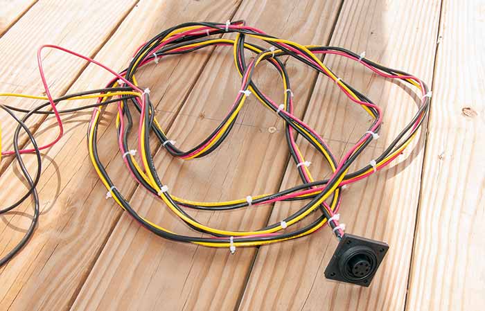 Make the electrical connections with a wiring loom from the socket and cut the wires long enough to snake through bulkheads