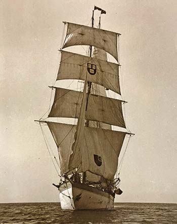 A large three-masted brigantine ­ship at sail