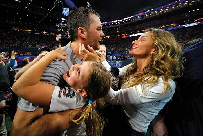 Tom Brady and his wife, Gisele, celebrate a win with daughter, Vivian