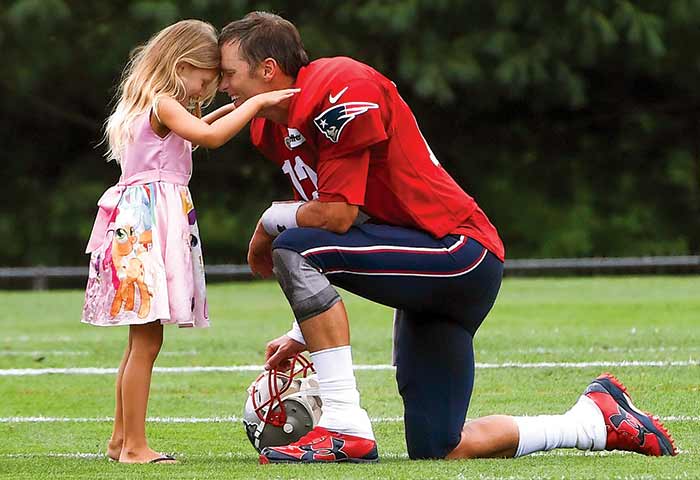 Tom Brady with daughter Vivian on the field