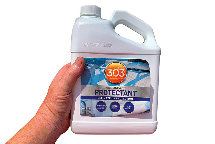 Product photo: Hand holding a bottle of 303 Aerospace UV Protectant