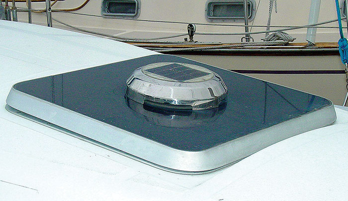 Close-up photo of a slor-powered mushroom vent installed on top of a boat dock by another boat