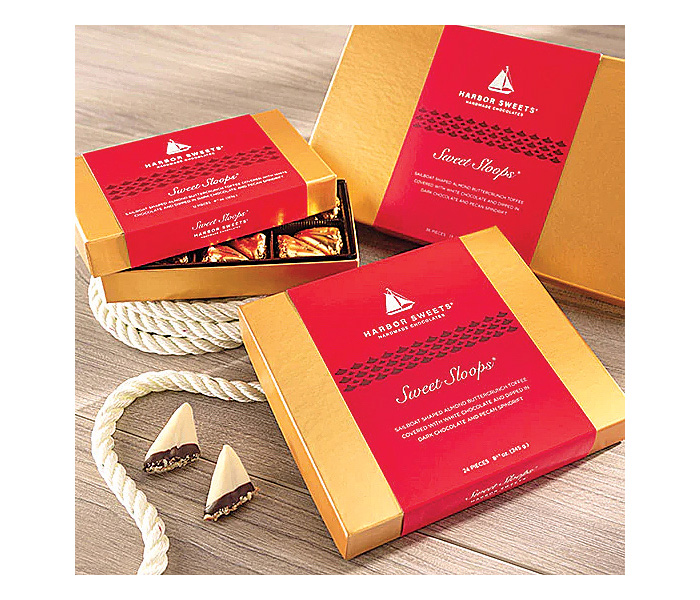 Three boxes of chocolate in gold and red packaging.