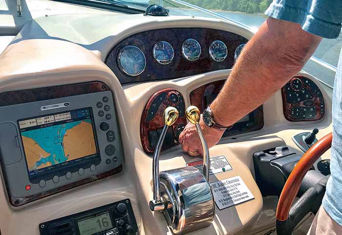 Older model chartplotter and GPS systems installed on boat helm
