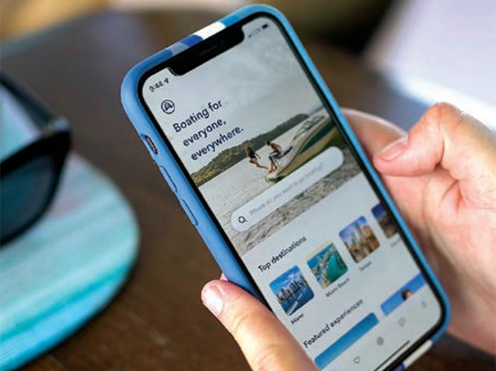 The Boatsetter app being used on an iPhone with a blue case