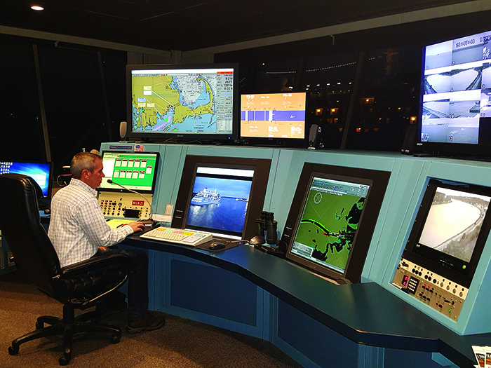 An adult male working at the marine traffic control center monitoring the Cape Cod Canal.