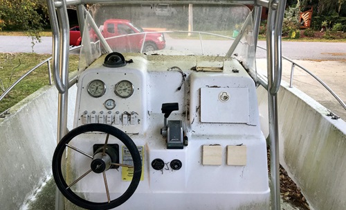 A weathered white boat steering console 