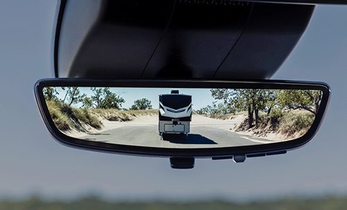 Vehicle approaching in a rear view mirror.