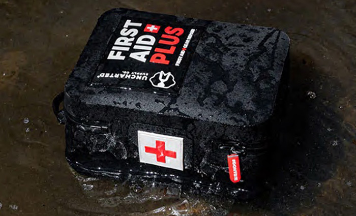 Black first aid plus kit submerged in water.