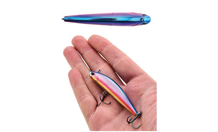 View of a hand holding a rainbow colored fishing lure