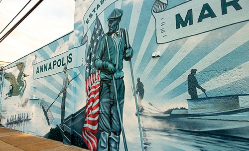 Large mural in Annapolis Maryland featuring a man holding a large American Flag.