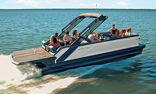 Nine passengers aboard a white, gray and blue pontoon boat cruising on a lake.