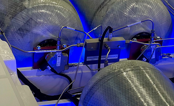Up close view of silver hydrogen-powered cylinders with blue backlight